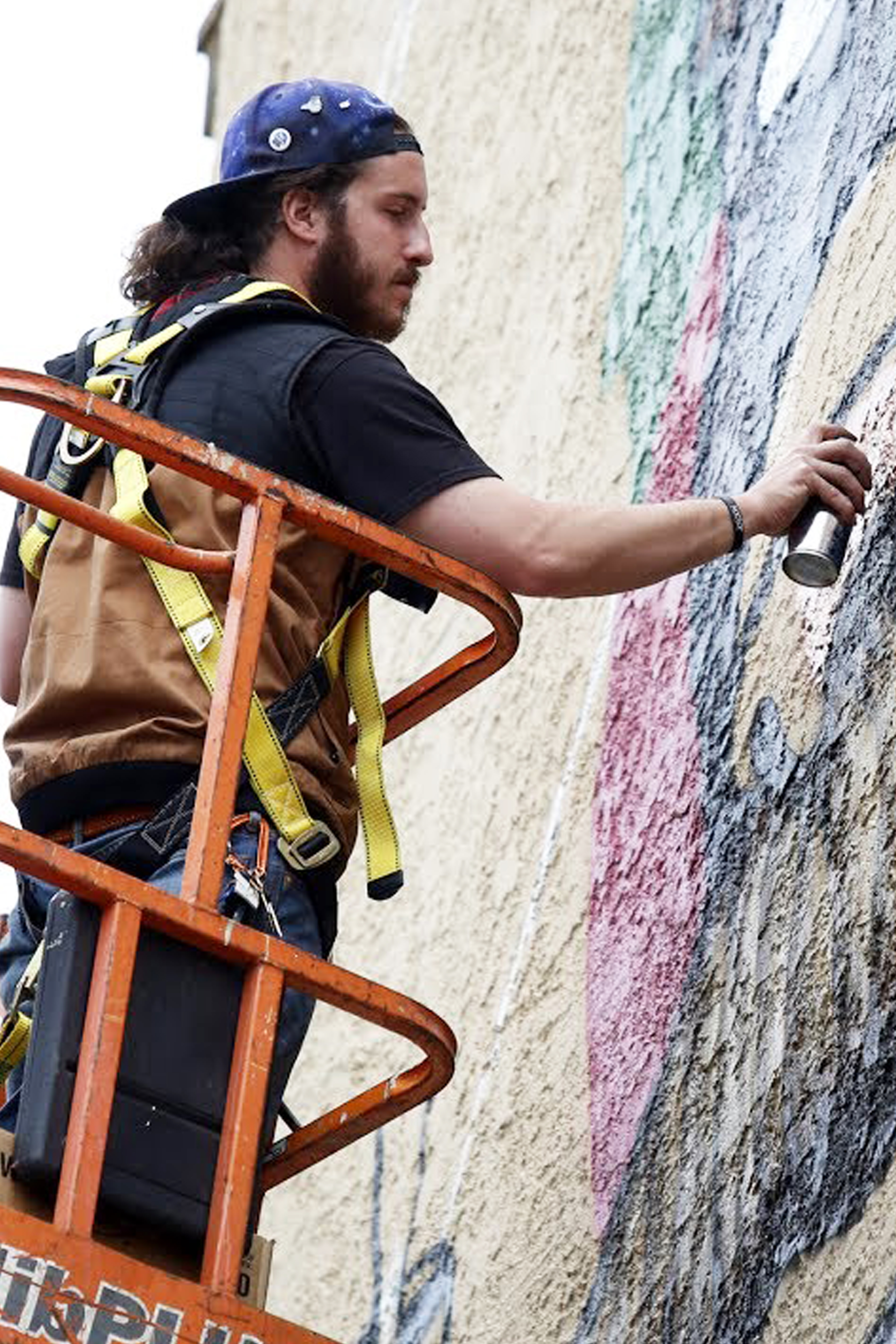 man painting mural